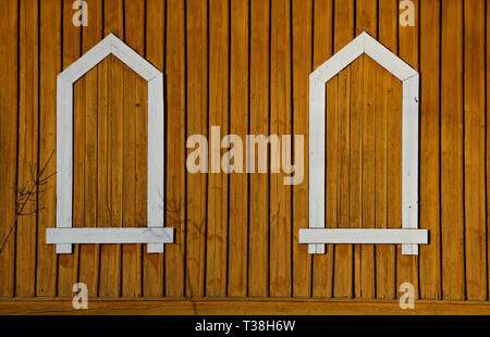 Fake window frames on a yellowish wall  in late afternoon sunshine Stock Photo