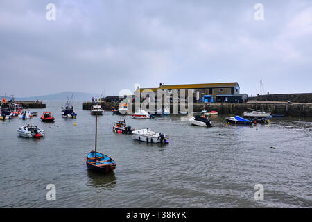 Pictured is the harbour for Lyme Regis named the Cobb with boats. Stock Photo