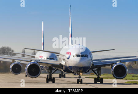 LONDON, ENGLAND - MARCH 2019: Boeing 777 long haul airliners operated by British Airways taxiing for take off at London Heathrow Airport. Stock Photo