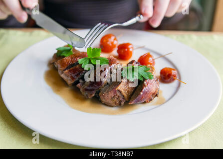 Duck roll in demi-glace sauce on a plate Stock Photo