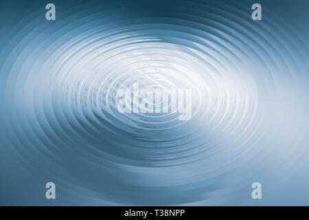 Rings on a blue water surface caused by a falling drop Stock Photo