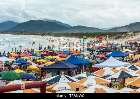 2019, January. Florianopolis, Brazil. Crowded beach full of umbrellas, in Joaquina Beach. Stock Photo