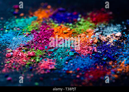 Crumbs of multi-colored chalk on a black background. Joy, Carnival. Panorama. A game for children. Art. Stock Photo
