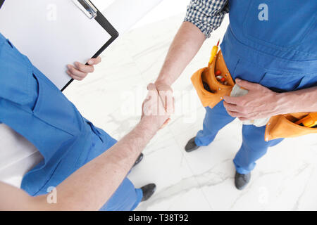 Two construction workers shaking hands, deal is finished concept Stock Photo