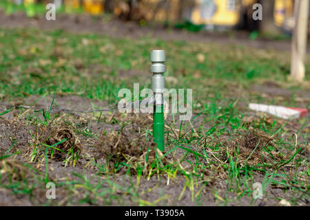 Fuse combat grenade, mortgaged to the ground. Mined territory. Fuse, moderator and grenade checks sticking out of the ground. Close-up. Anti-personnel Stock Photo