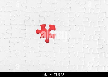 White blank jigsaw puzzle without one piece. Missing part and incompleteness theme Stock Photo