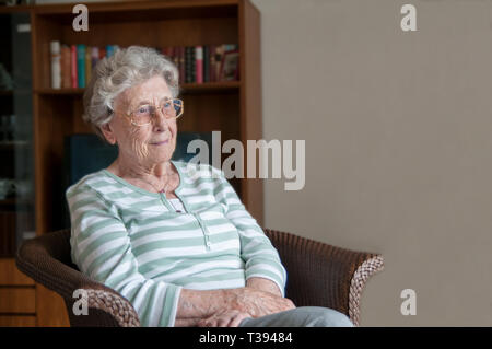 Old senior sitting alone on his walker Stock Photo