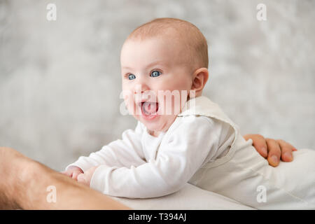 Portrait of laughing baby with blue eyes Stock Photo