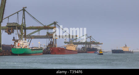 Nautical bulk carrier ships in iron ore harbour at Rotterdam port, The Netherlands Stock Photo