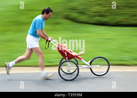 Father Jogging with his baby daughter in stroller, USA Stock Photo