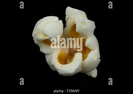 Macro image of a piece of popcorn isolated on a black background Stock Photo