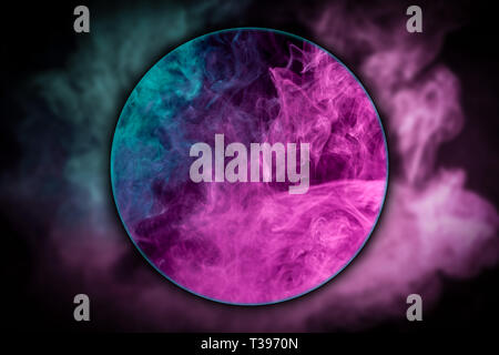 Close-up   thick pink and blue smoke blown under a magnifying glass on a black isolated background. Background from the smoke of vape Stock Photo