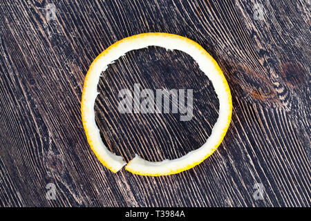 Peel orange mandarin lying on a black wooden floor after cleaning citrus fruits Stock Photo