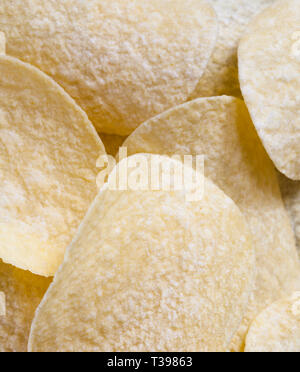 light-colored thin potato chips made from mashed potatoes, natural to the harmful product on the table Stock Photo