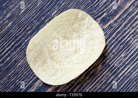 light-colored thin potato chips made from mashed potatoes, natural to the harmful product on the table Stock Photo