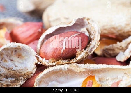 Peeled peanuts lying in the husk of roasted on the fire, close-up of food Stock Photo