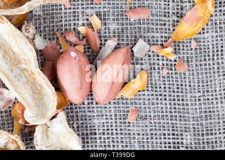 Peeled peanuts lying in the husk of roasted on the fire, close-up of food Stock Photo