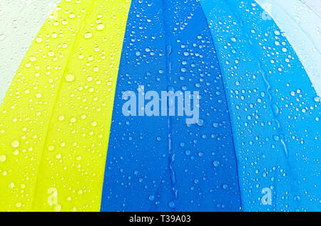 Covered with small and large drops of water, a quality umbrella that protects from precipitation, rain outside Stock Photo