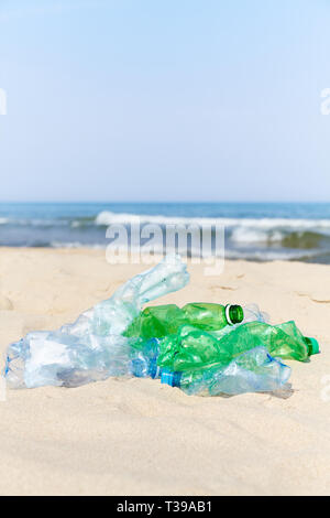 Used plastic bottles on a beach, selective focus. Stock Photo