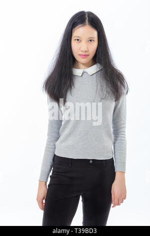 Three quarter length portrait of eenage Asian high school girl Stock Photo