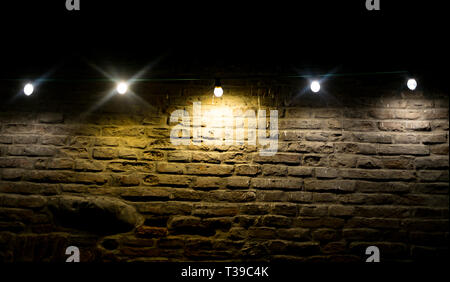 Incandescent and led bulbs on brick wall Stock Photo