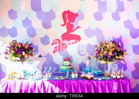 Sea time mermaid theme on the party's candy bar with purple background. Birthday party for girls, teens. Stock Photo