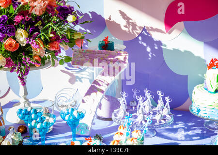 Sea time mermaid theme on the party's candy bar with purple background. Birthday party for girls, teens. Stock Photo