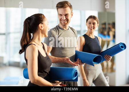 Handsome man practicing yoga with girls Stock Photo