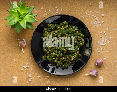 Stewed lentils with spinach. Second dish. Flat lay. The view from the top. Stock Photo