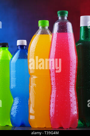 Plastic bottles of assorted carbonated soft drinks in variety of colors Stock Photo