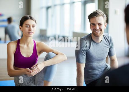 Young people chatting before yoga class Stock Photo