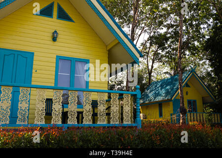 KO CHANG, THAILAND - APRIL 8, 2018: Typical resort houses for tourists - Vivid yellow and blue camping place buildings - Asian Stock Photo