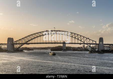 Sydney, Australia - February 12, 2019: Harbour bridge under an evening twilight sky. Ferry boat. Stock Photo