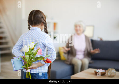 Girl Surprising Grandma Stock Photo