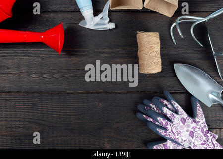 Gardening tools on dark wooden background. Spring garden work concept Stock Photo