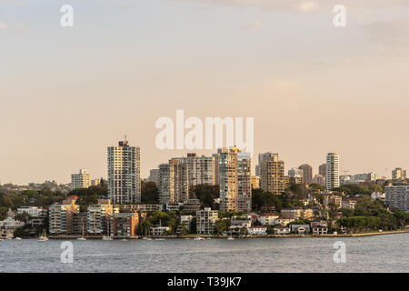 Sydney, Australia - February 12, 2019: Upscale neighborhood around McKell Park bordering the bay under an evening twilight sky. Stock Photo