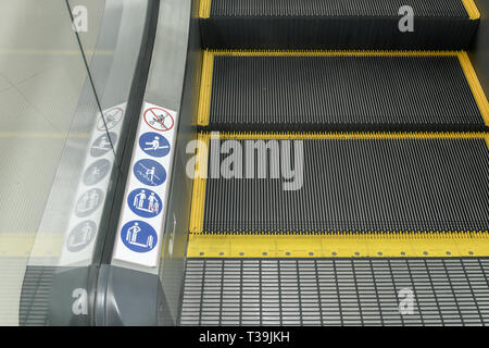 Security, Safety signs on an escalator in a shop, London UK Stock Photo ...