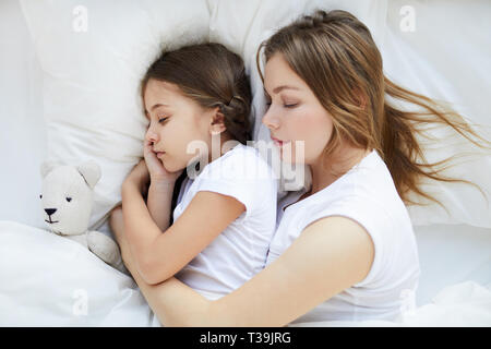 Woman Sleeping with Child Above View Stock Photo