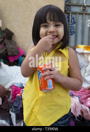 Young girl with softdrink at market in Yangon, Myanmar Stock Photo