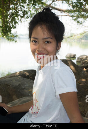 Girl posing for photo on the shore of Kandawgyi Lake, Yangon, Myanmar Stock Photo