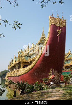 Royal barge and Karaweik or Karaweik Hall is a palace on the eastern shore of Kandawgyi Lake, Yangon, Myanmar Stock Photo