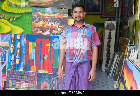 Owner standing in front of his art gallery in  Bogyoke Aung San Market  in  Yangon, Myanmar (Burma) Stock Photo