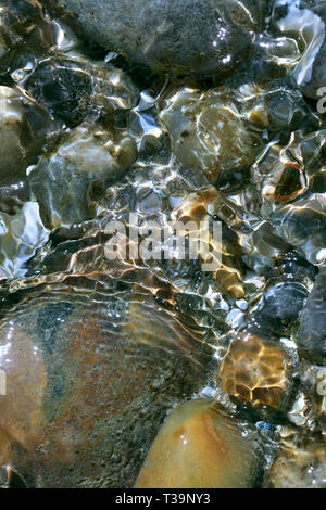 Close up of ripples of water in a rock pool on a beach, Brighton. Stock Photo