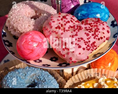 Arrangement of colorful doughnuts and easter eggs Stock Photo