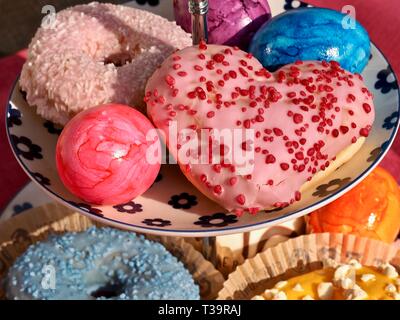 Arrangement of colorful doughnuts and easter eggs Stock Photo