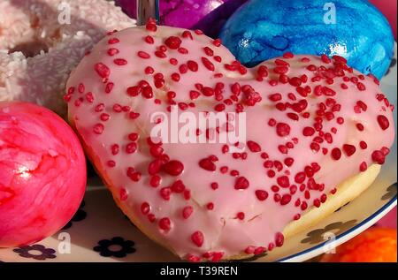 Arrangement of colorful doughnuts and easter eggs Stock Photo