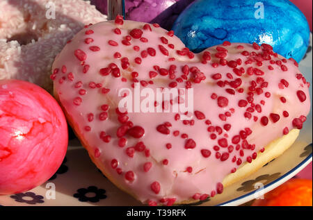 Arrangement of colorful doughnuts and easter eggs Stock Photo