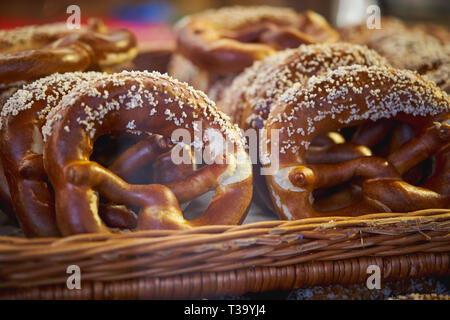 Pretzels in a wooden basket on display in a bakery. They are a type of baked bread product made from dough most commonly shaped into a twisted knot. L Stock Photo