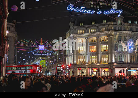 London, UK - November, 2018. Oxford Street in central London decorated with Christmas lights and crowded with people on a shopping spree. Stock Photo