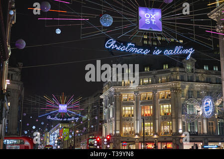 London, UK - November, 2018. Oxford Street in central London decorated with Christmas lights and crowded with people on a shopping spree. Stock Photo